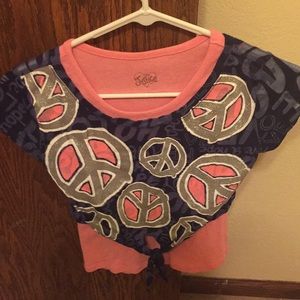 A short sleeve shirt with symbols all around it.
